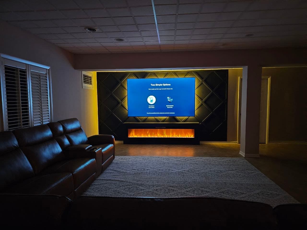 Black diamond lattice media wall, wide view of a home theater seating area