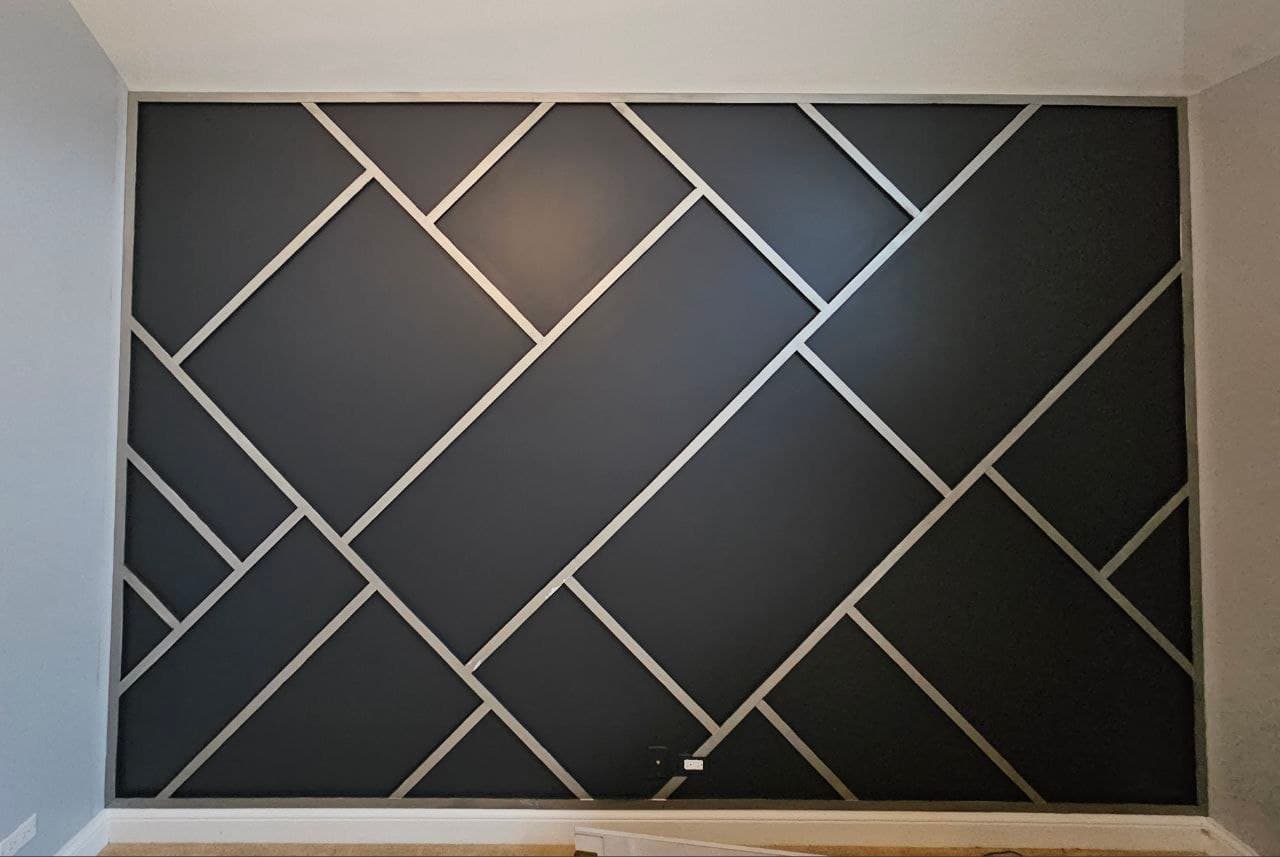 Detail shot of a black diamond-pattern board & batten accent wall
