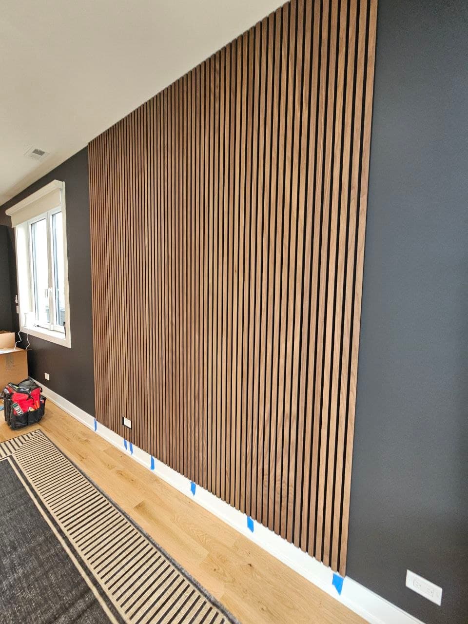 Light oak wood slat accent wall along a sloped loft ceiling